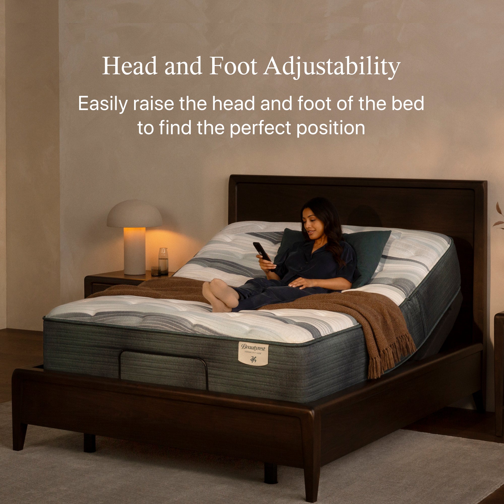 Woman laying on a mattress holding an adjustable base remote.  The mattress is slightly elevated  within the adjustable base and both are in a brown bed frame.   Headline at the top of the image states Head and Foot Adjustability  Easily raise the head and foot of the bed to find the perfect position