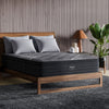 The Beautyrest Black b-class mattress in a bedroom on a wooden bed|| series: grand b-class || feel: plush pillow top