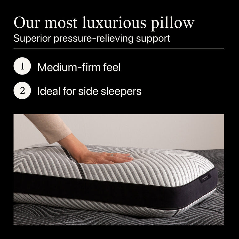 A hand pressing on the Beautyrest Black Luxury Foam Pillow, showing the firmness level
