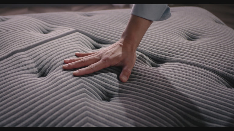 Hand pressing the fabric of the Beautyrest Black mattress||series: deluxe c-class