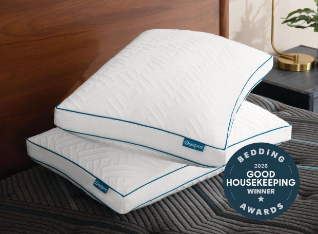 Two Beautyrest pillows on a bed with a Good Housekeeping award badge