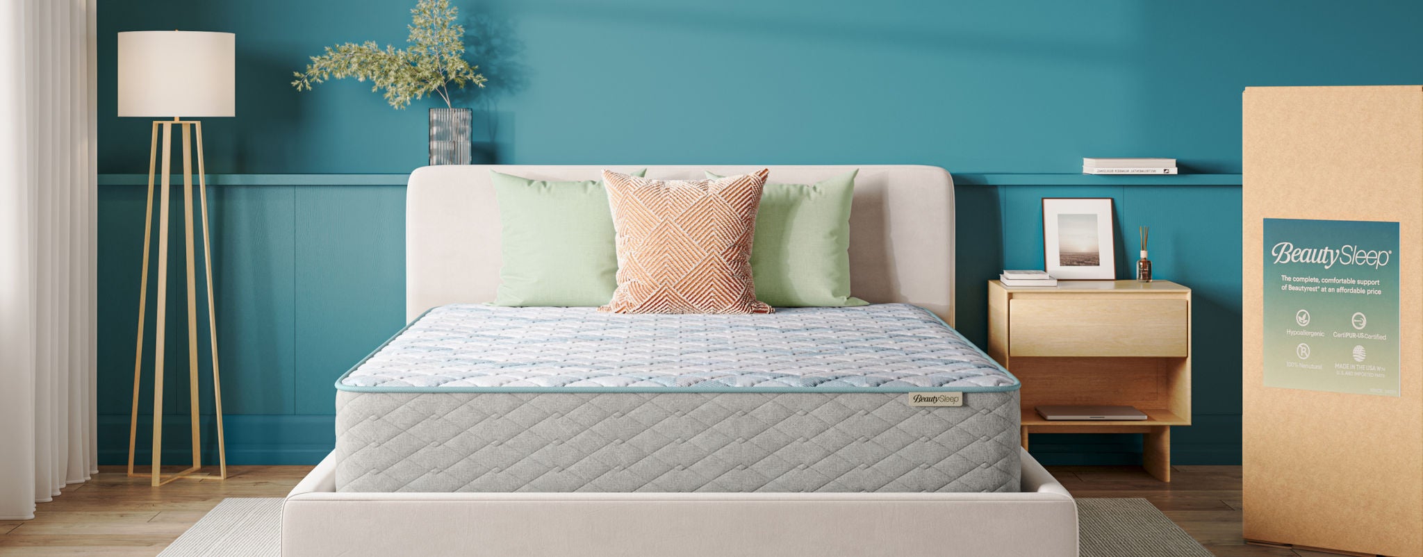 Beautysleep Soothing Nights mattress in a grey bed frame with the packaging box to the right of it.