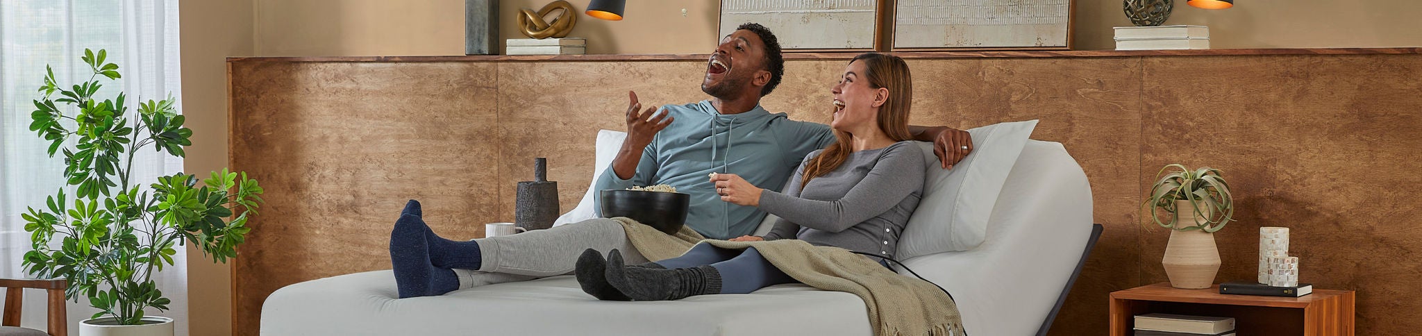 Couple relaxing on adjustable bed