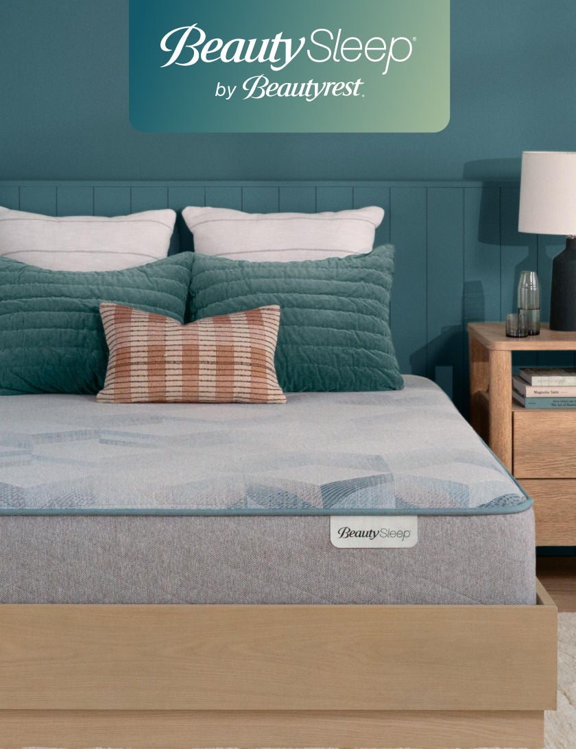 Beautysleep Mattress in a Box in a brown bedframe with 5 pillows on top