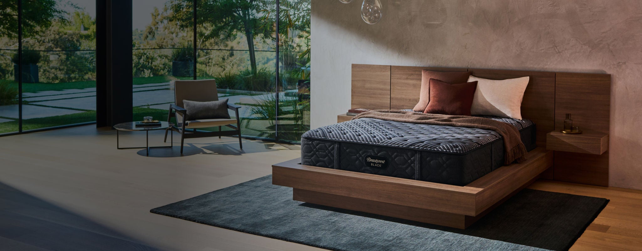 Beautyrest mattress sitting on top of a brown bed frame with 3 pillows on top of it.