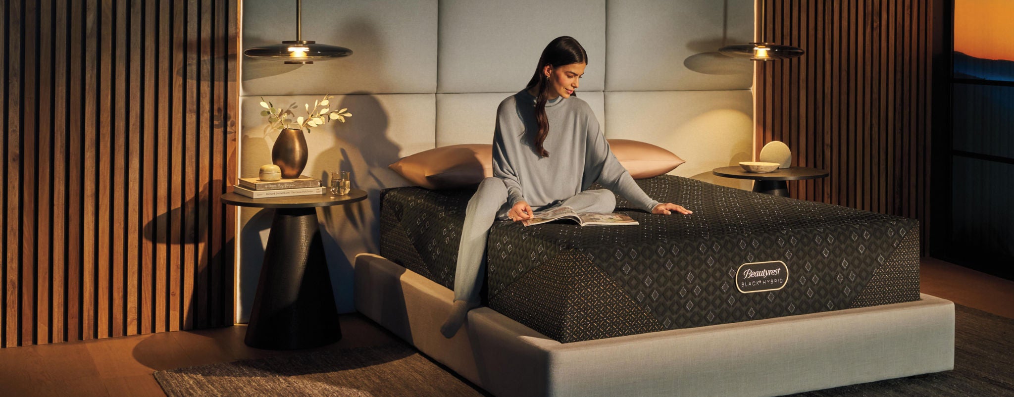 Woman sitting on a Beautyrest mattress in a bedroom