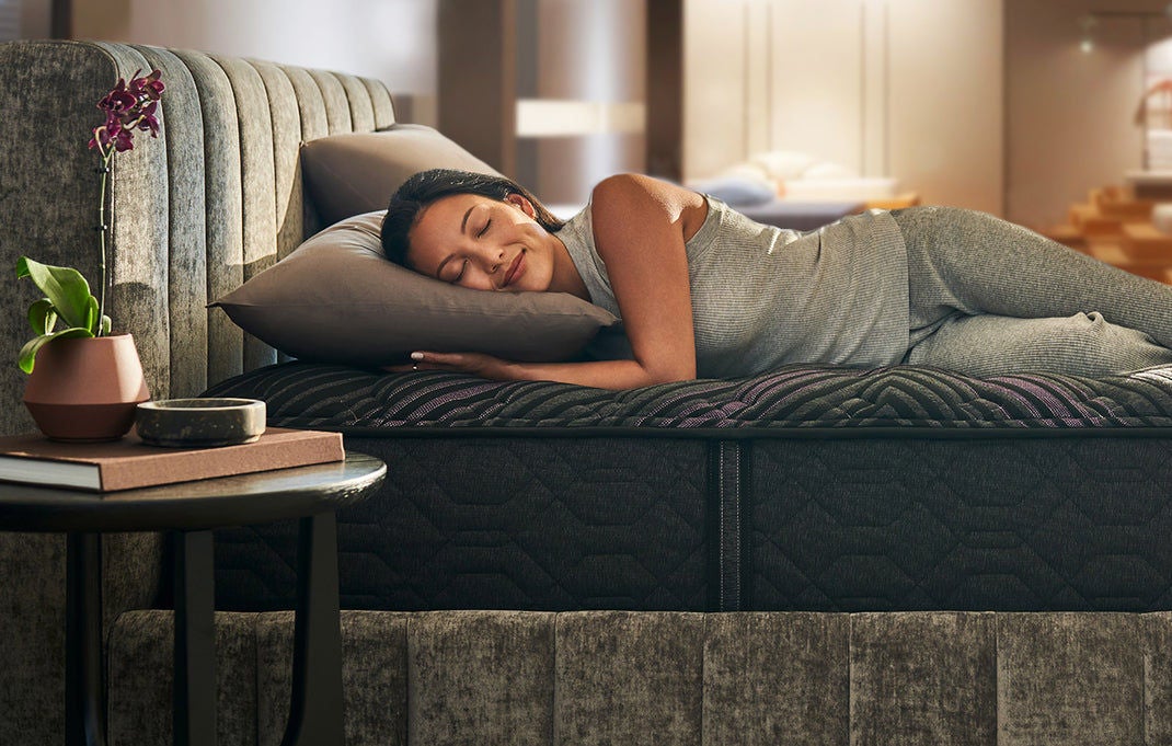 Woman sleeping on modern mattress