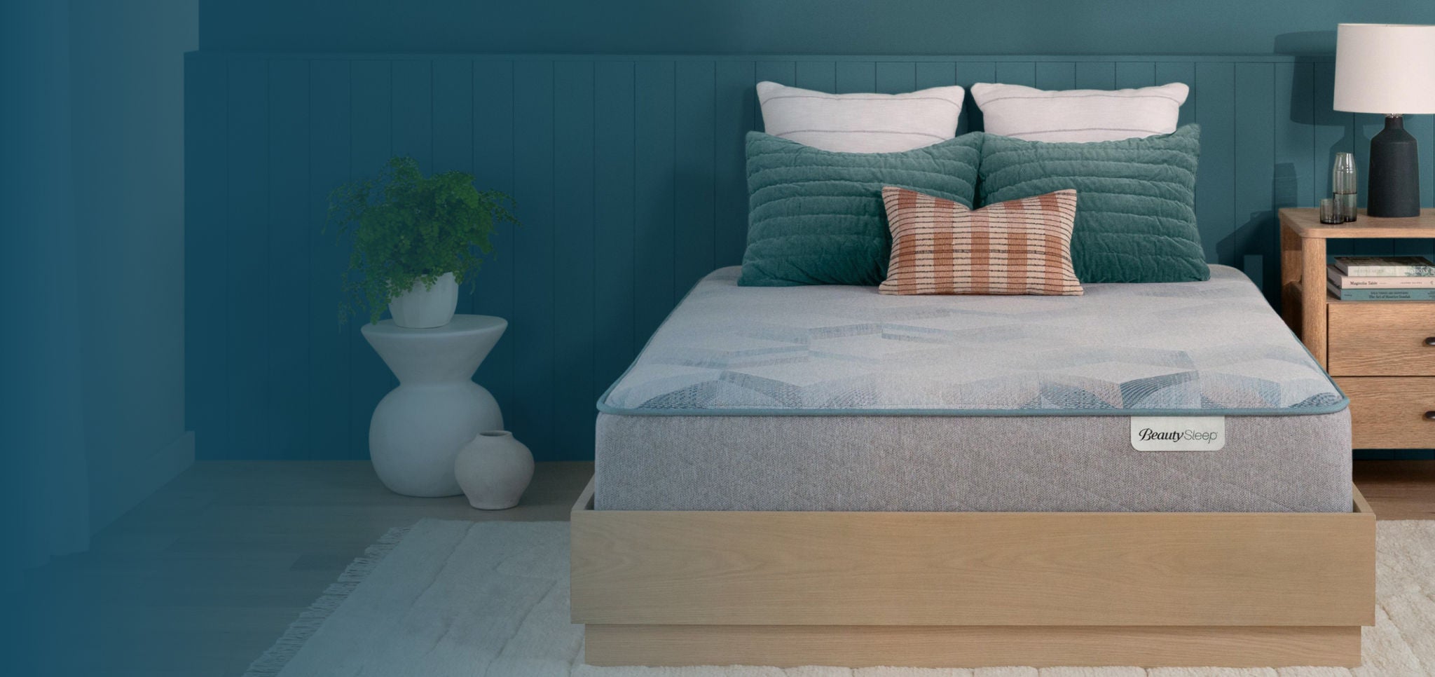 Beautysleep Mattress in a Box in a brown bedframe with 5 pillows on top