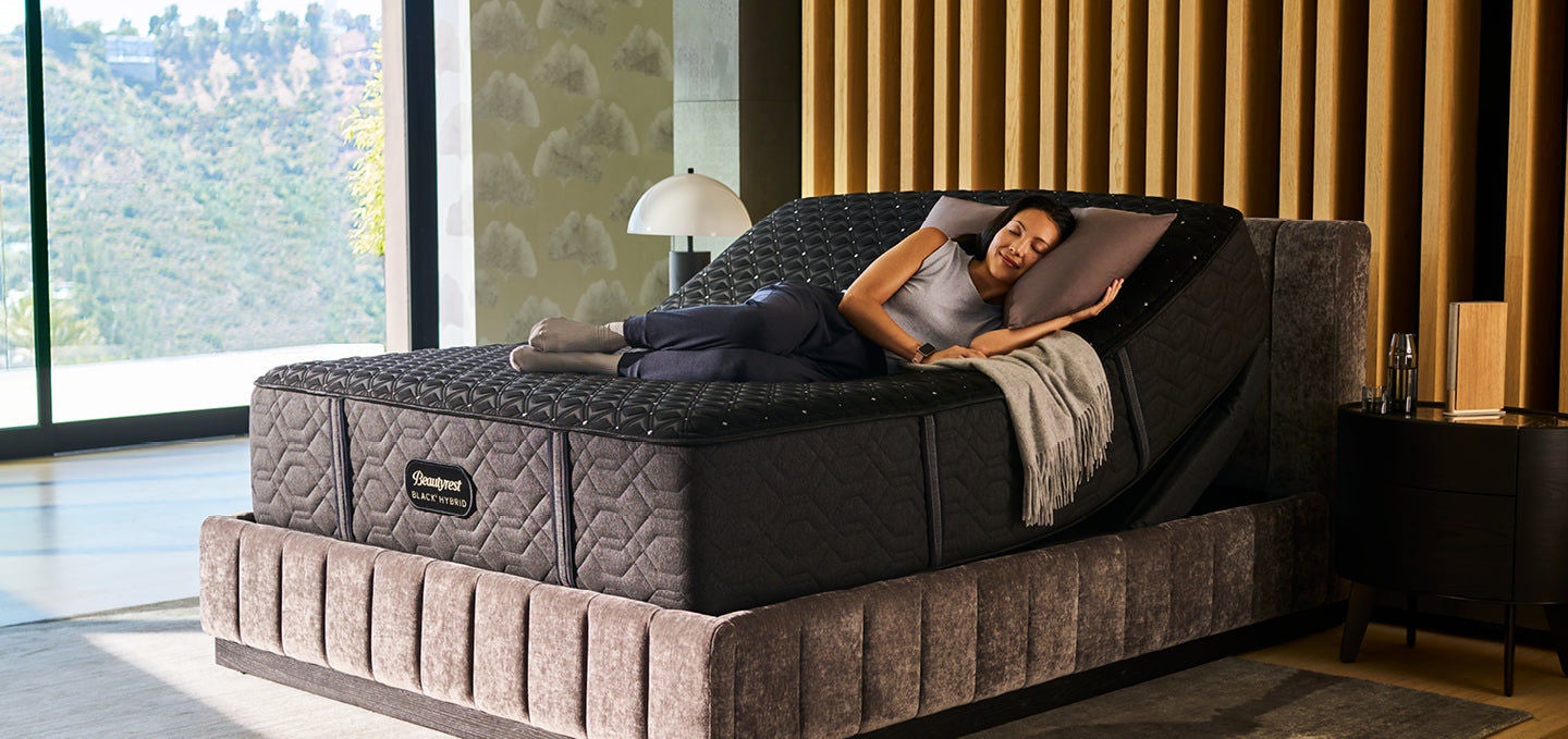 Woman relaxing on adjustable mattress in modern room