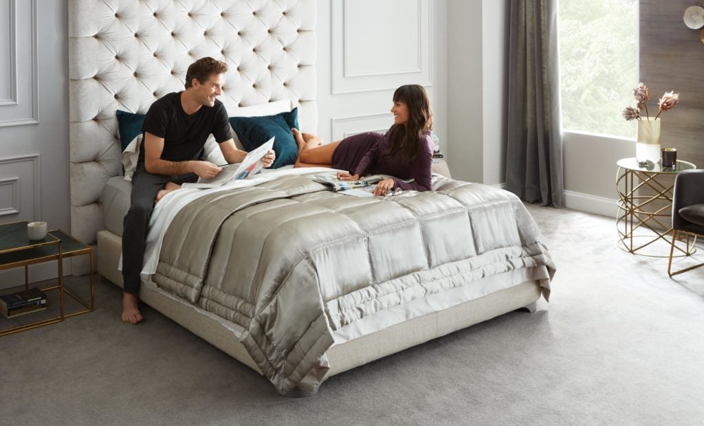 Couple relaxing in modern bedroom setting