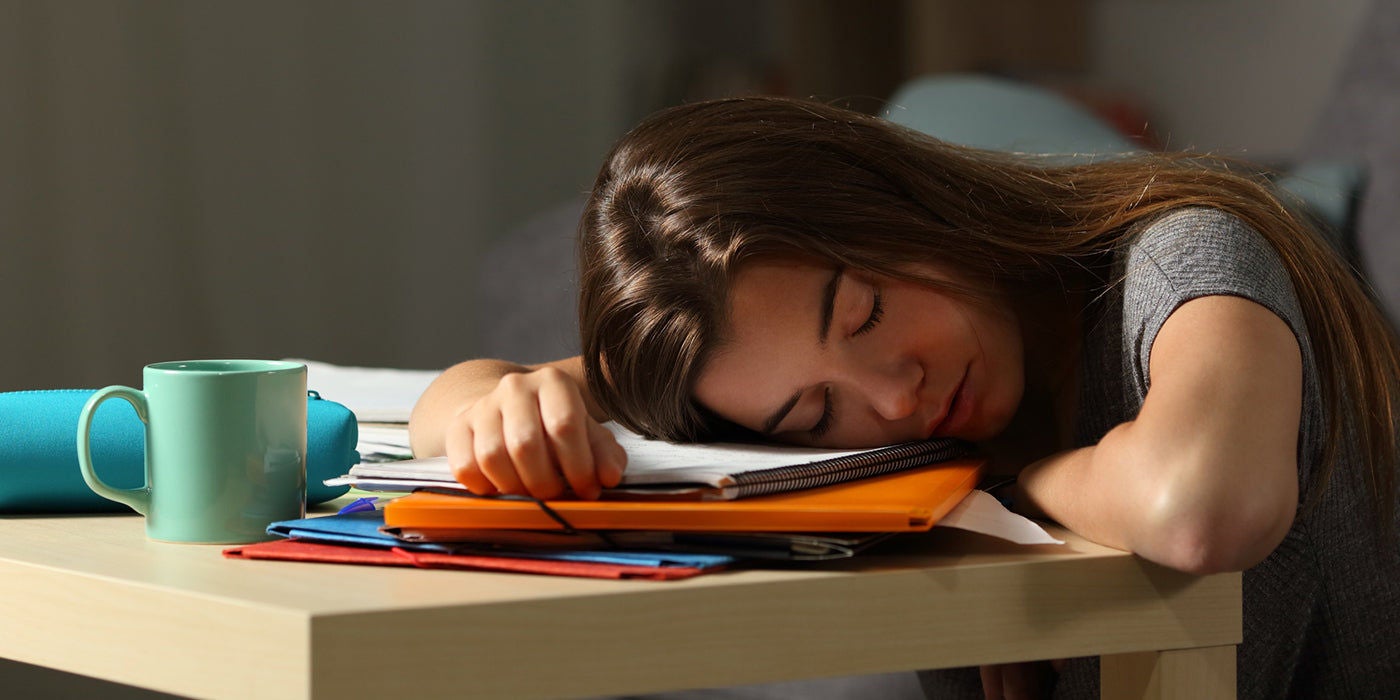 Exhausted student resting on desk