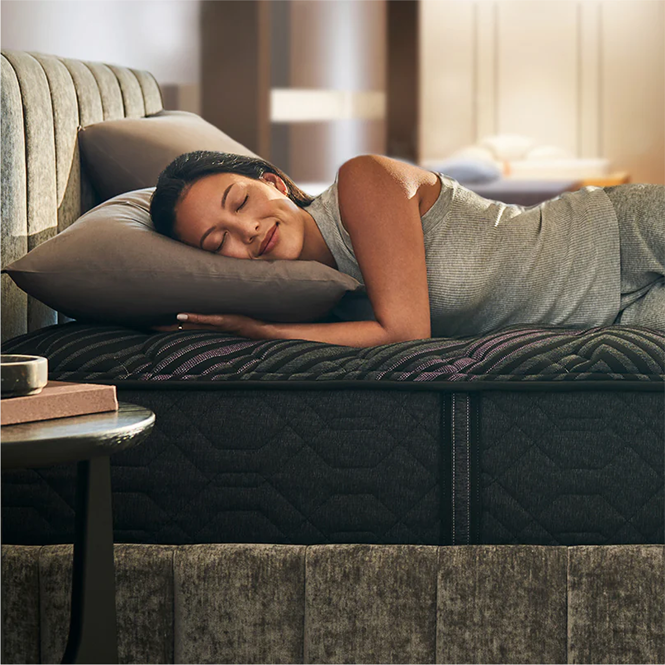 Woman resting on modern mattress
