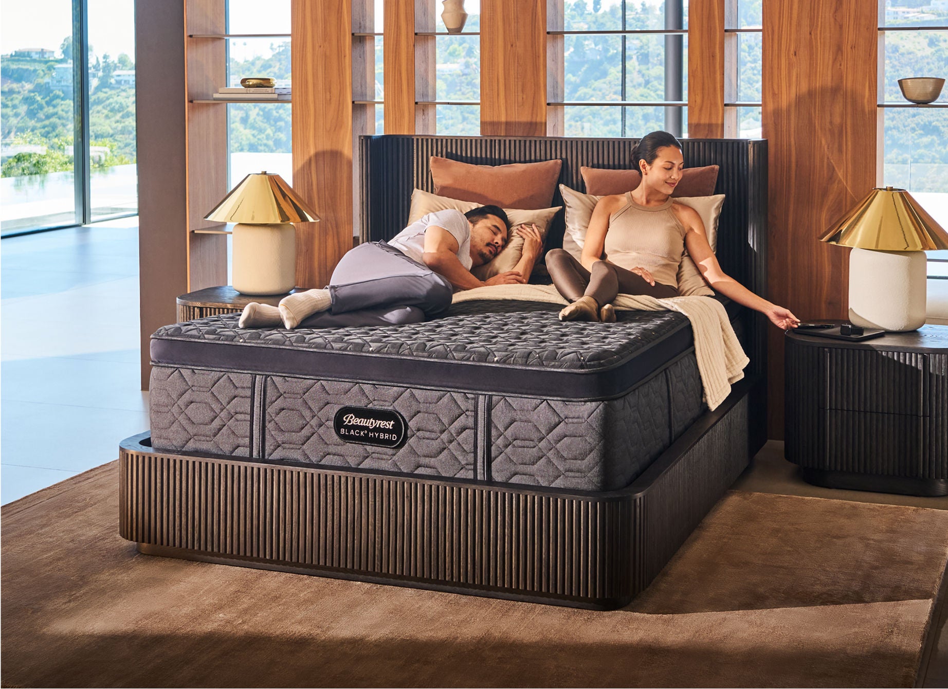 Man asleep and woman sitting up on a Beautyrest Black mattress