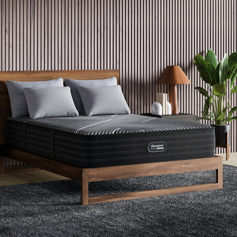 The Beautyrest Black hybrid mattress in a bedroom on a wooden bed || series: grand bx-class || feel: firm