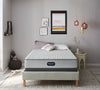 The Beautyrest BR800 Firm mattress in a bedroom on a beige bed