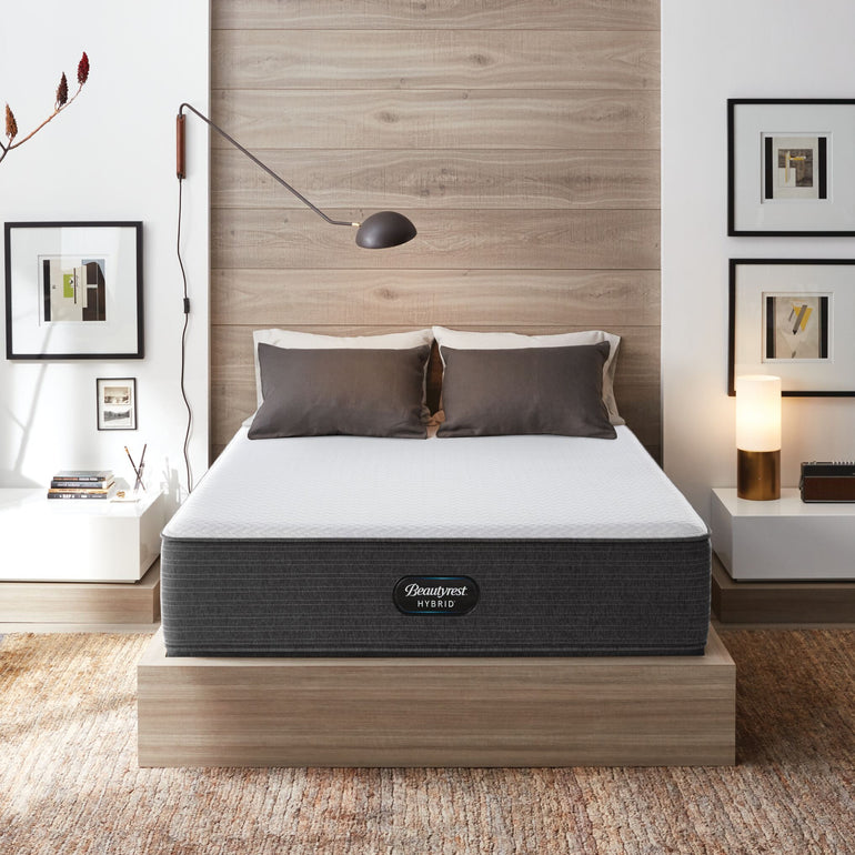 The Beautyrest Select hybrid mattress in a bedroom on a wooden bed||feel: Firm