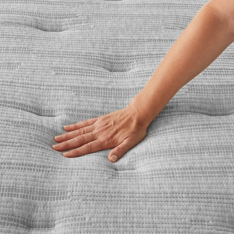 Hand pressing on the Beautyrest Select Mattress to show firmness level ||feel: Plush Pillow Top