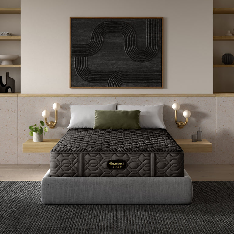 The Beautyrest Black extra firm mattress in a bedroom on a grey bed frame || series: Series One || feel: extra firm