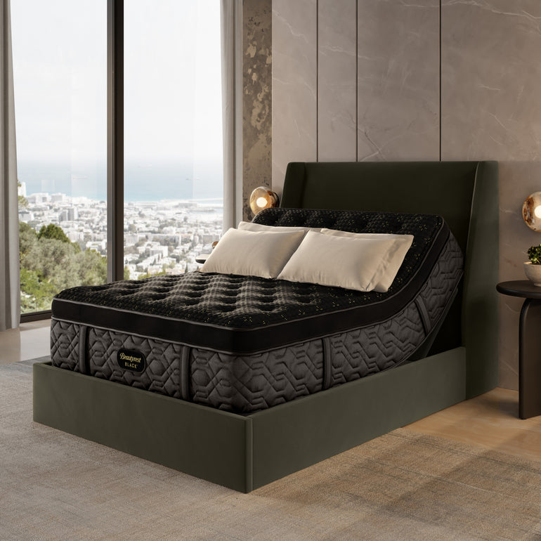 The Beautyrest Black mattress in a bedroom on an adjustable frame sitting in a forest green bed frame || series: Series Four