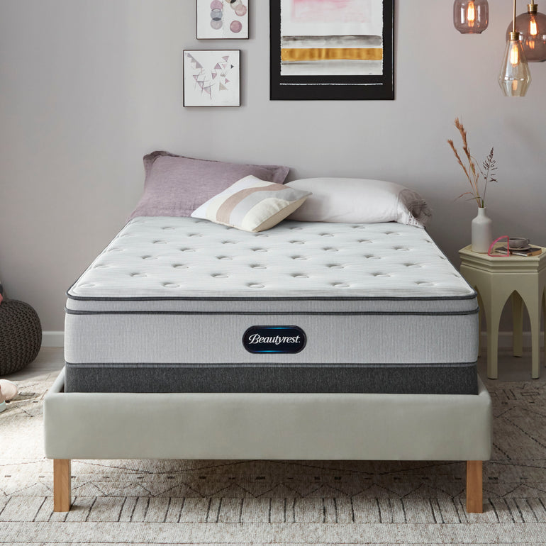 The Beautyrest BR800 Plush Euro Top mattress in a bedroom on a beige bed