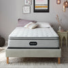 The Beautyrest BR800 Medium Pillow Top mattress in a bedroom on a beige bed