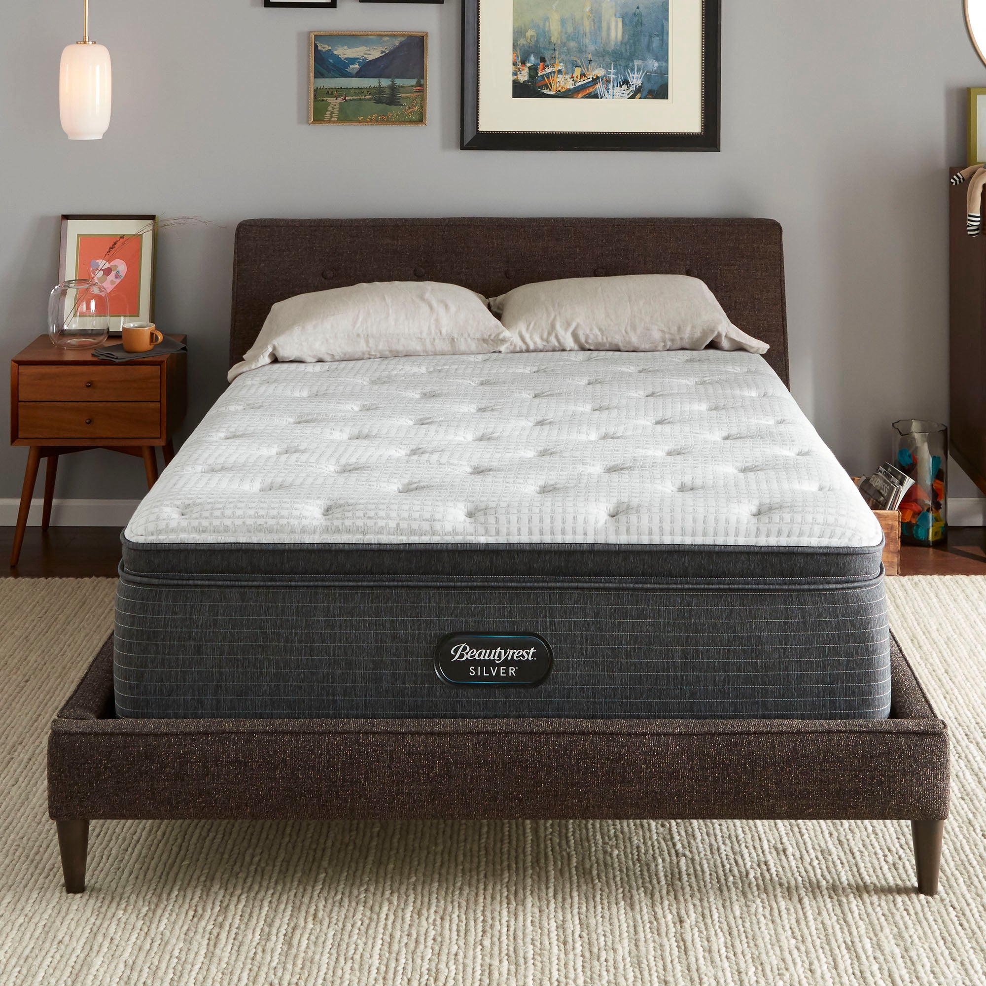 The Beautyrest Silver BRS900-C Plush Pillow Top mattress in a bedroom on a brown bed