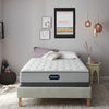 The Beautyrest BR800 Medium mattress in a bedroom on a tan bed
