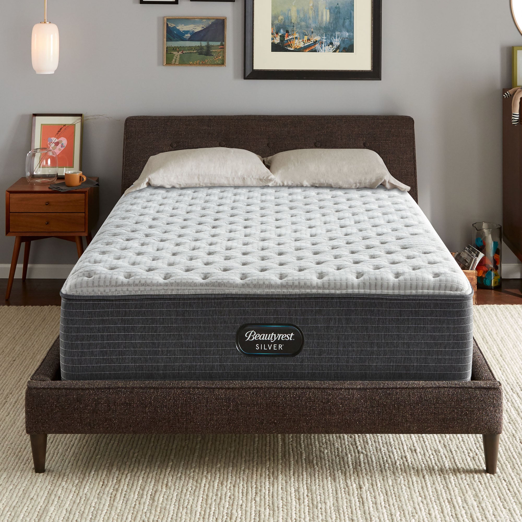The Beautyrest Silver BRS900-C Extra Firm mattress in a bedroom on a brown bed