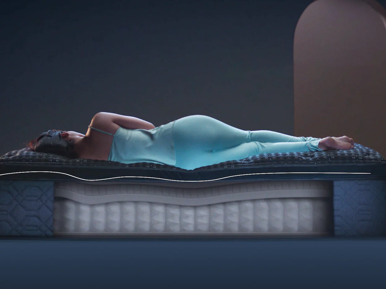 Woman laying on a Beautyrest mattress with proper spinal alignment