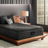 The Beautyrest Black hybrid mattress in a bedroom on a wooden bed||series: deluxe cx-class