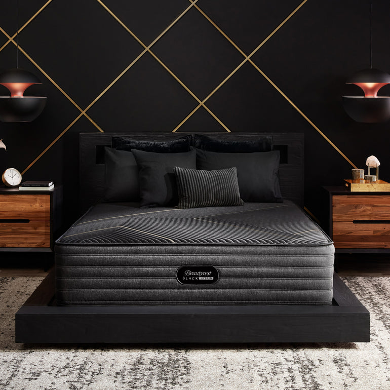 The Beautyrest Black hybrid mattress in a bedroom on a black bed||series: exceptional kx-class