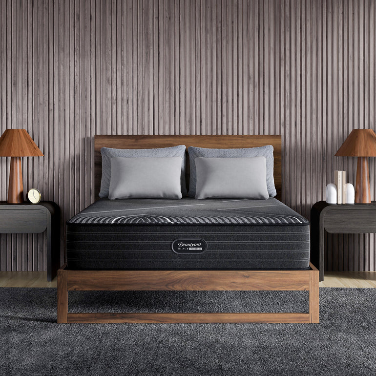 The Beautyrest Black hybrid firm mattress in a bedroom on a wooden bed || series: grand bx-class || feel: firm