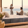 Two men having coffee next to the Beautyrest Harmony hybrid Exceptional Driftwood Bay mattress|| series: Exceptional Driftwood Bay