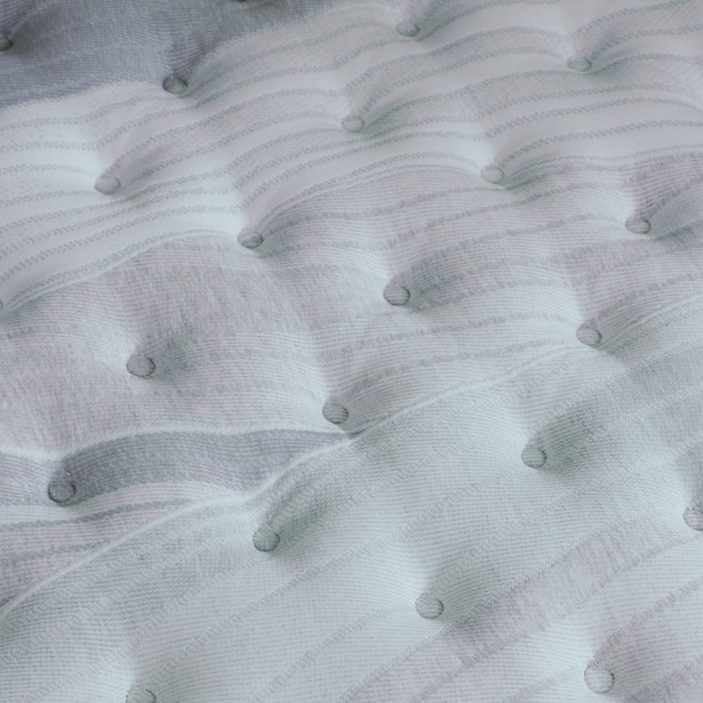 A hand pressing on the material of the Beautyrest Harmony Lux mattress || series: Premier Anchor Island || feel: firm 