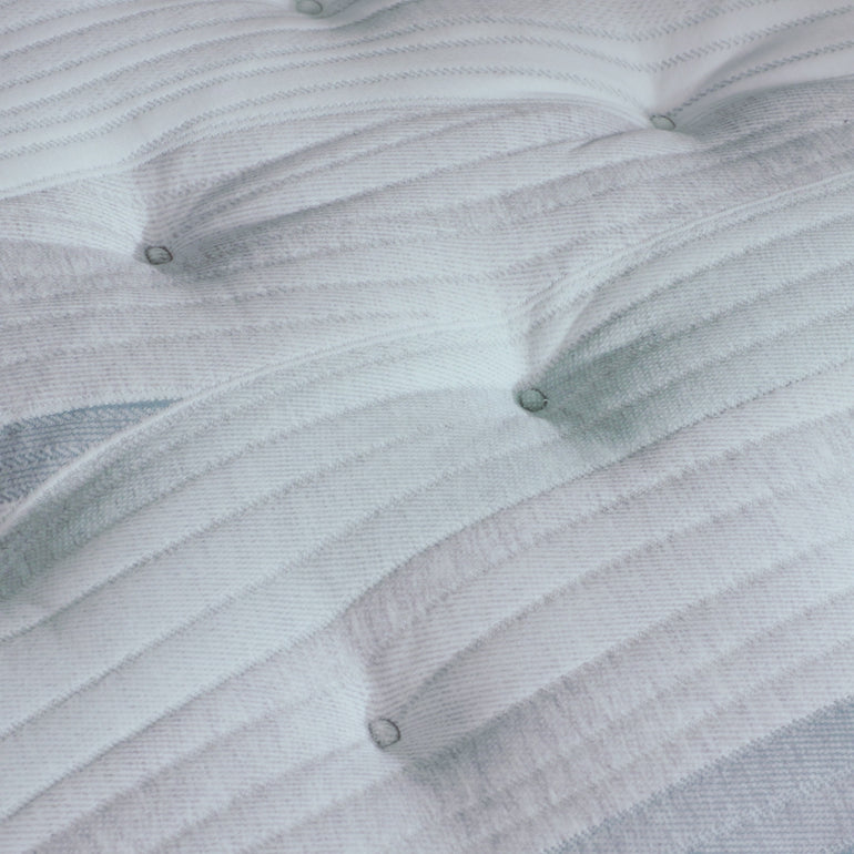 A hand pressing on the material of the Beautyrest Harmony Lux mattress || series: Premier Anchor Island || feel: medium