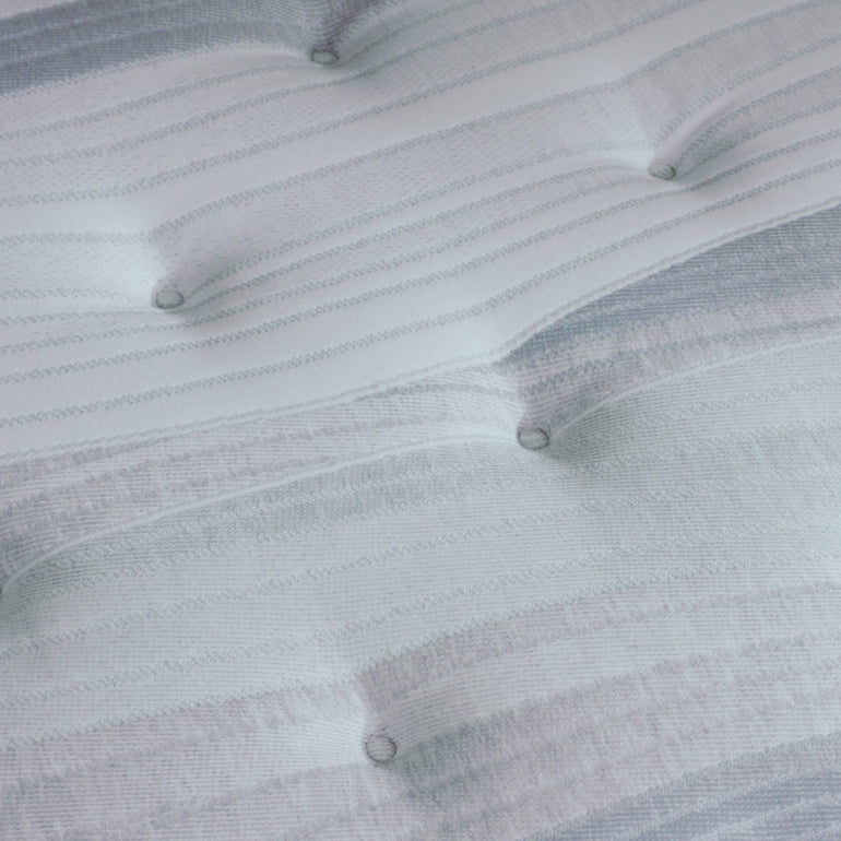 A hand pressing on the material of the Beautyrest Harmony Lux mattress || series: Premier Anchor Island || feel: plush