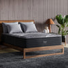 The Beautyrest Black b-class mattress in a bedroom on a wooden bed|| series: grand b-class || feel: extra firm