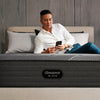 Man laying on the Beautyrest Black mattress looking at his phone || series: grand b-class || feel: plush