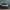 The Beautyrest Harmony Lux mattress in a bedroom against a blue wall