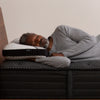 A man sleeping in bed on a Beautyrest Black Luxury Foam Pillow