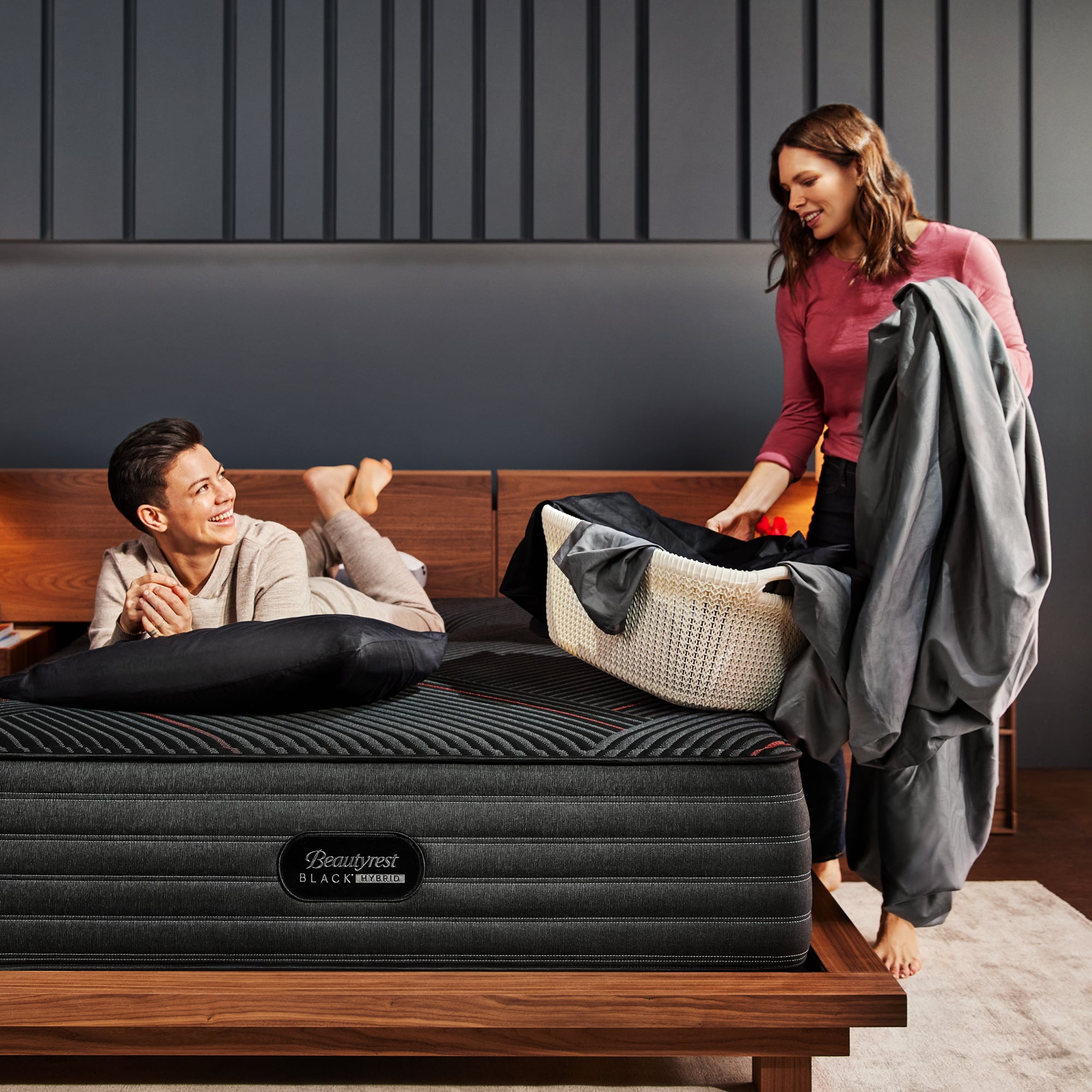 Couple folding laundry on the Beautyrest Black hybrid mattress||series: deluxe cx-class