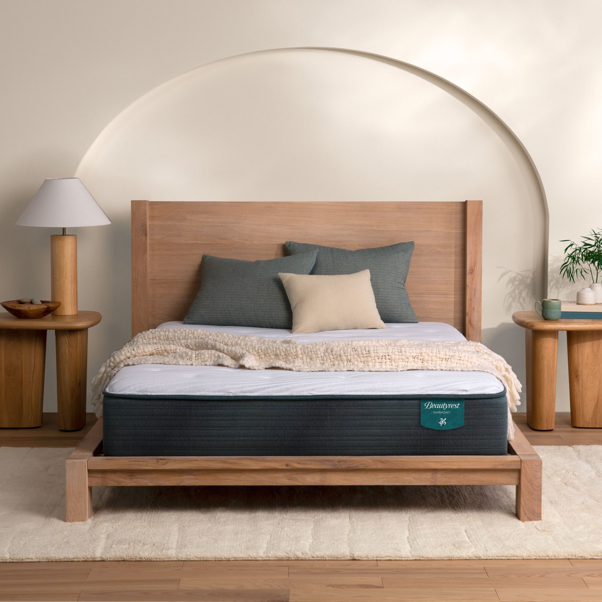 The Beautyrest Harmony medium mattress in a bedroom on a wooden bed|| series: Premier Beachfront Bay || feel: medium
