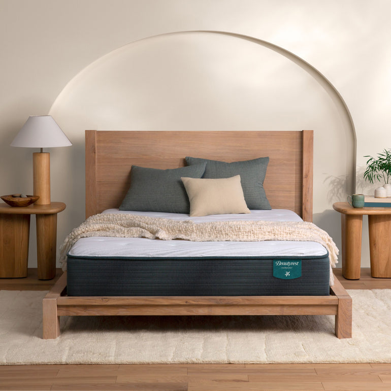 The Beautyrest Harmony medium mattress in a bedroom on a wooden bed|| series: Premier Beachfront Bay || feel: medium