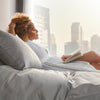 Woman reading in bed on a Beautyrest Black hybrid mattress || series: grand bx-class || feel: firm