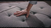 Hand pressing the fabric of the Beautyrest Black mattress||series: deluxe c-class
