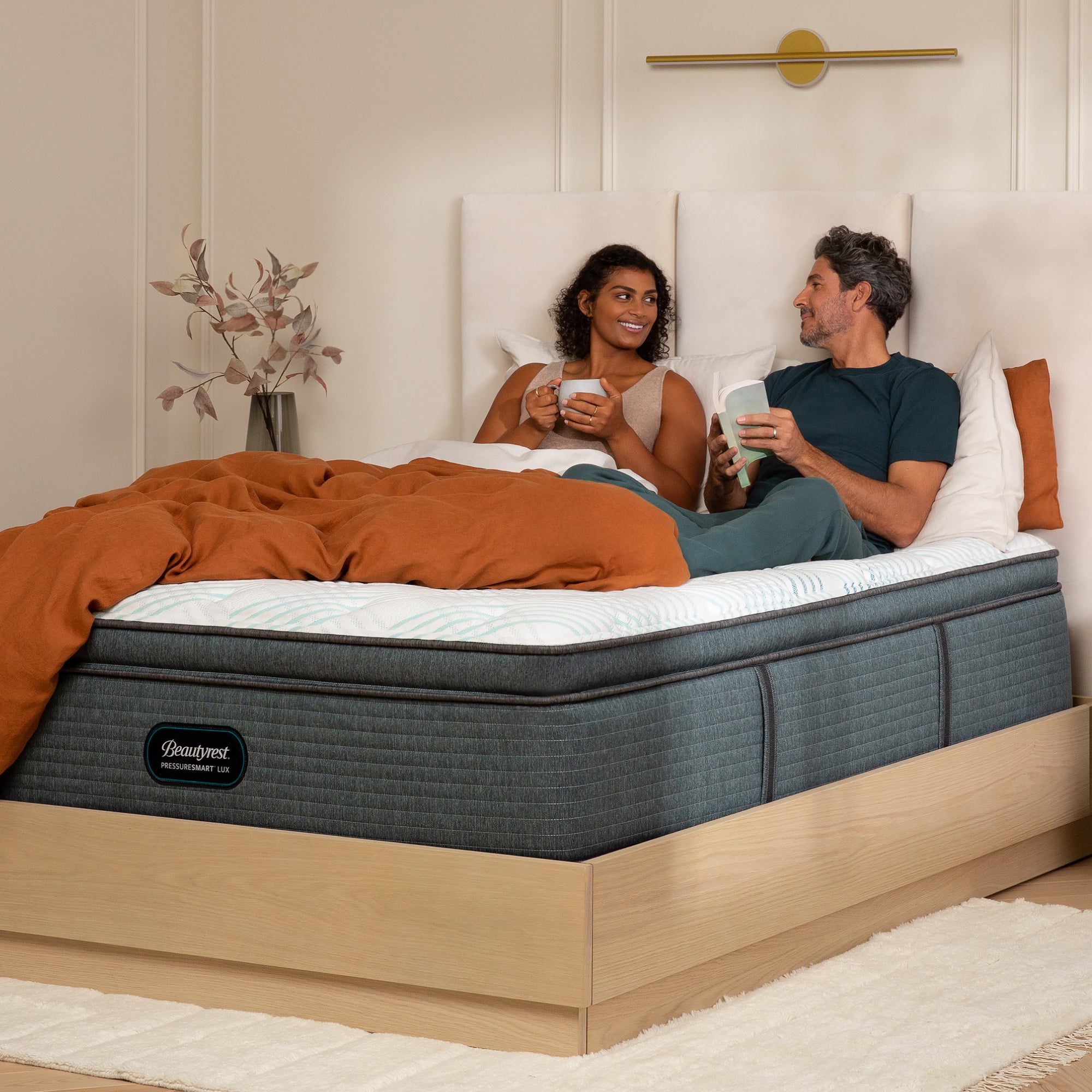 Man and woman enjoying coffee in bed on the Beautyrest PressureSmart mattress||feel: plush pillow top||series: lux