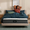 Woman stretching in her bedroom on the Beautyrest PressureSmart mattress || feel: firm || series: standard