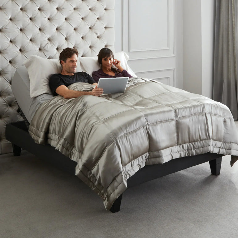 A couple reading in bed on a Beautyrest Black Luxury Base