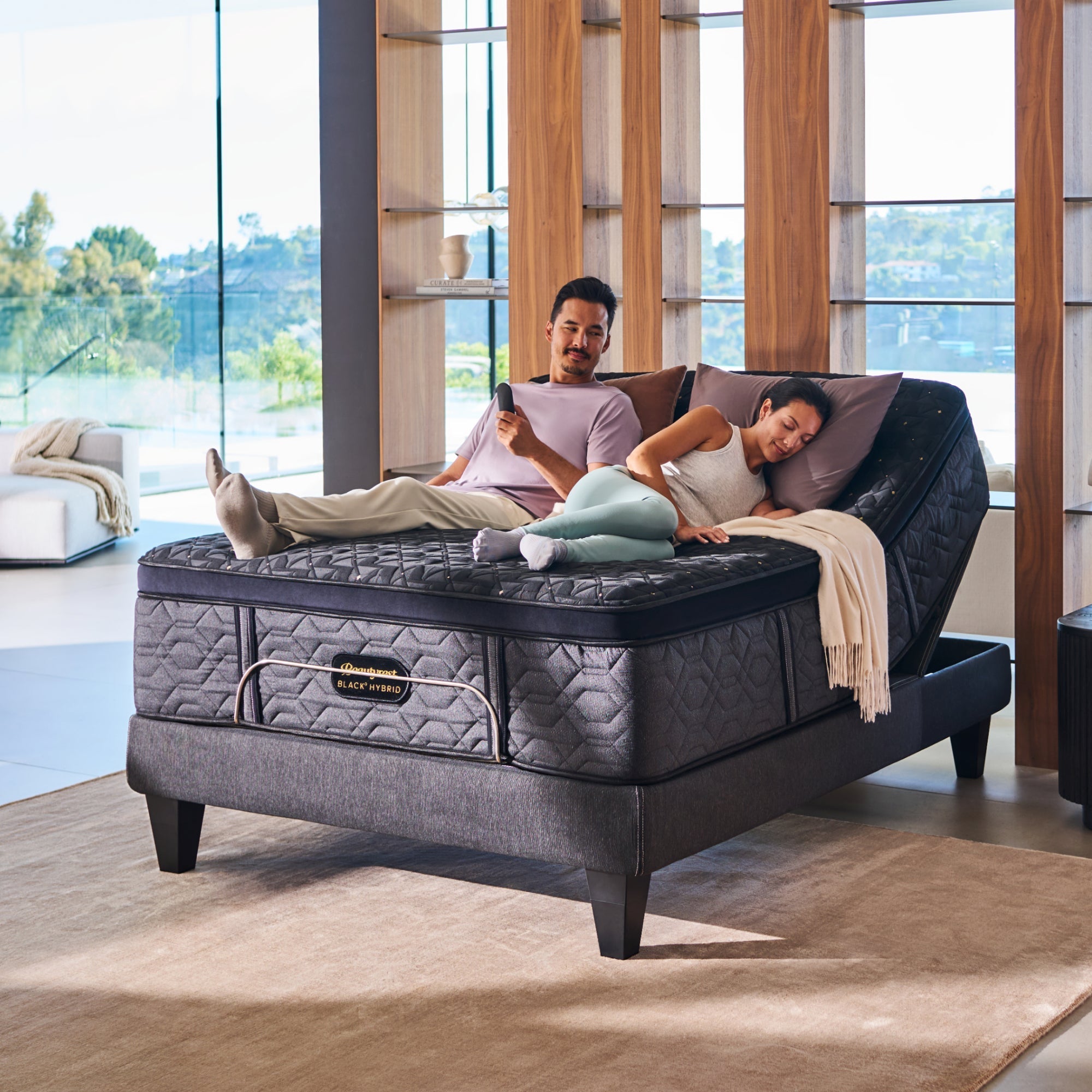 Close-up of mattress edge and pocketed coil design on gray fabric base, showcasing reinforced sides.